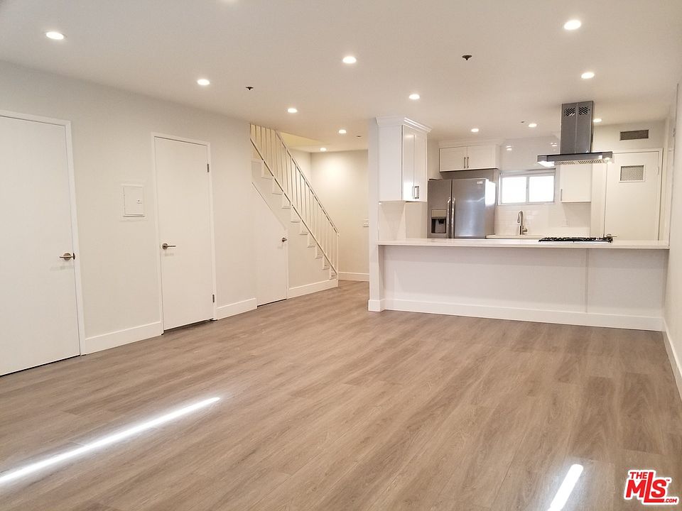 Renovated townhome interior - living area and kitchen